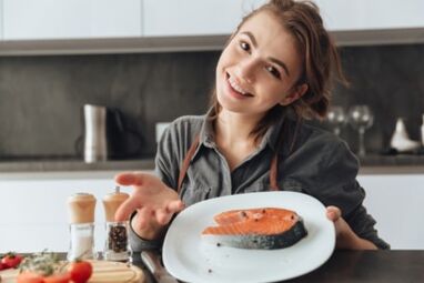 Young girl with trout fillet